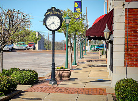 downtown street with shops and town clock